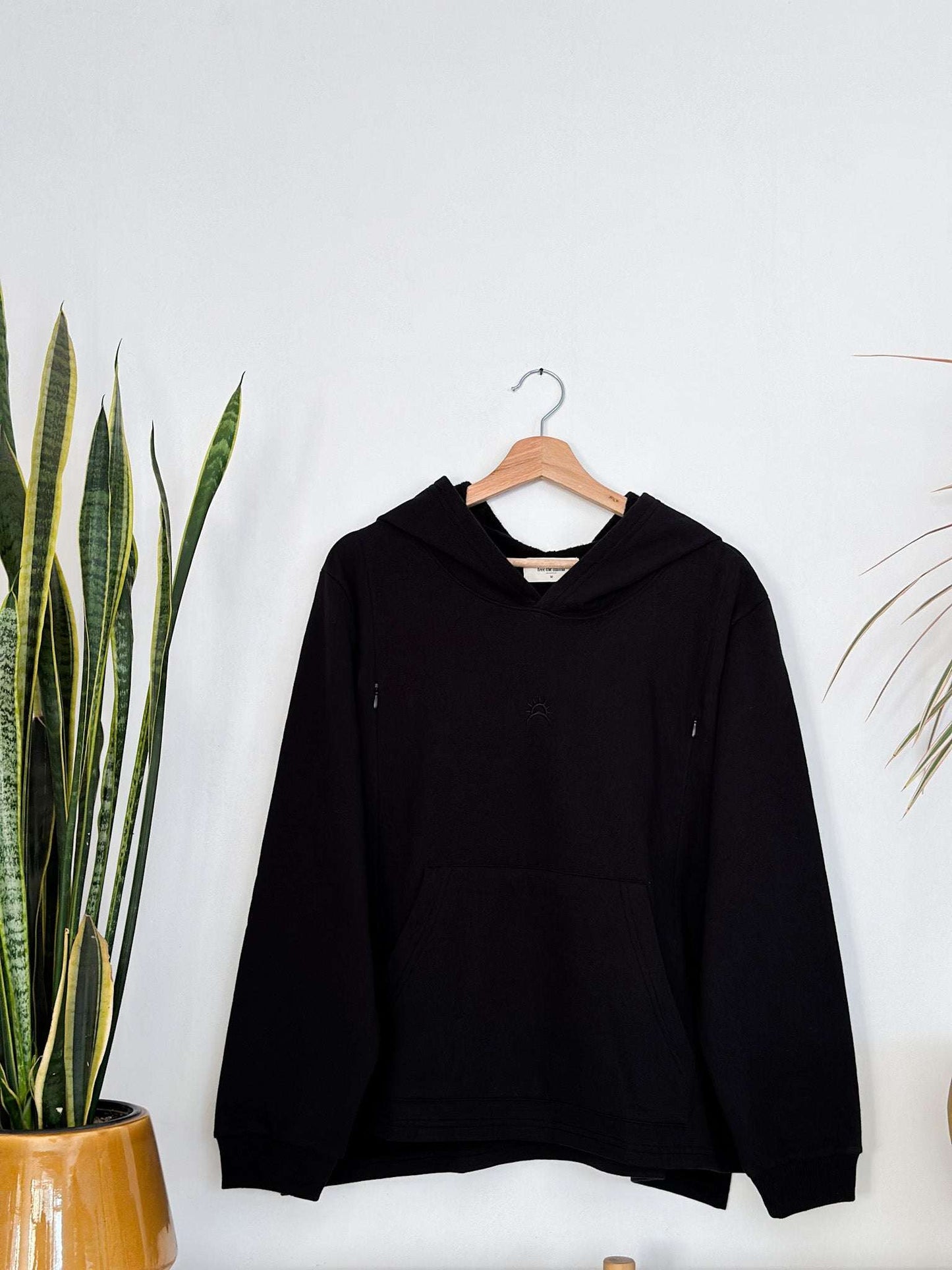Black nursing hoodie with oversized fit and side zippers, made of soft Peruvian pima cotton.