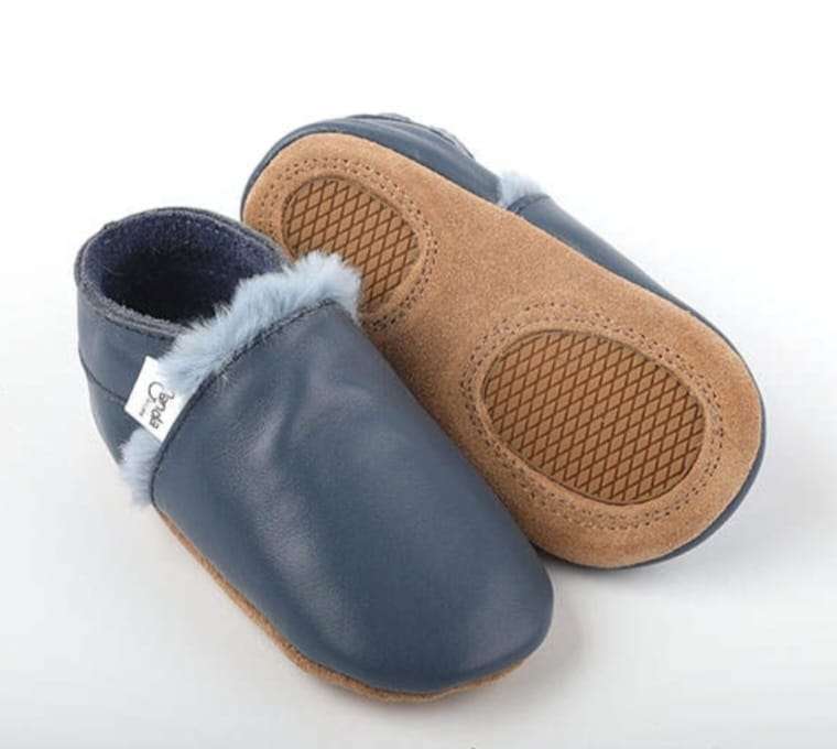 Ergonomic winter moccasins for infants with soft interior and non-slip sole.