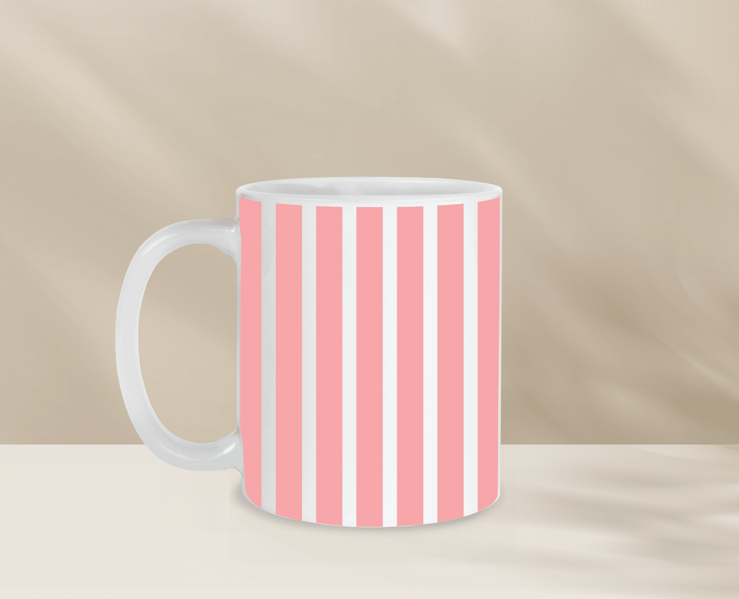 Pink and white striped coffee mug on a neutral background.