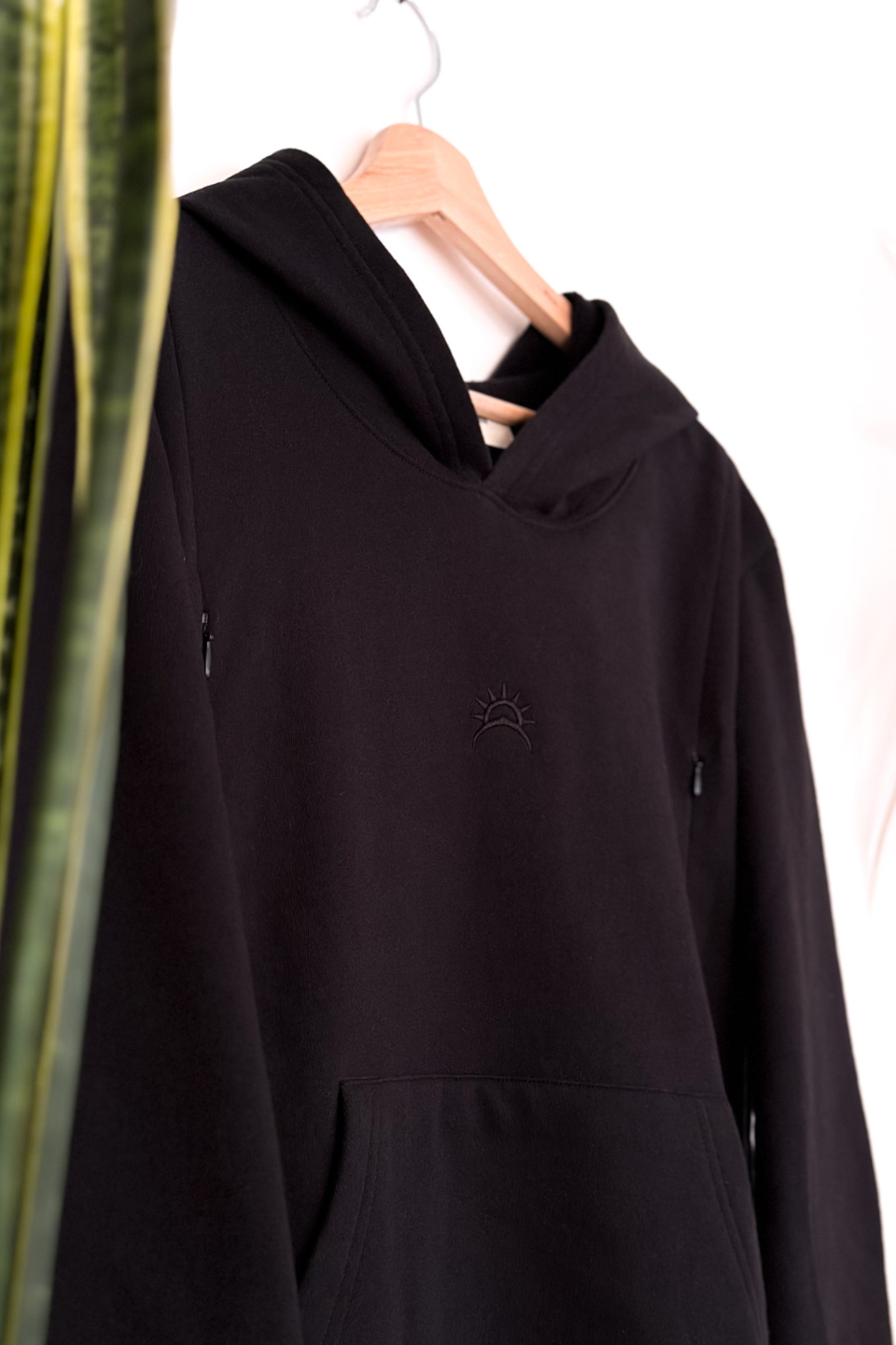 Black maternity hoodie with side zippers and embroidered logo, made from soft Peruvian Pima cotton.