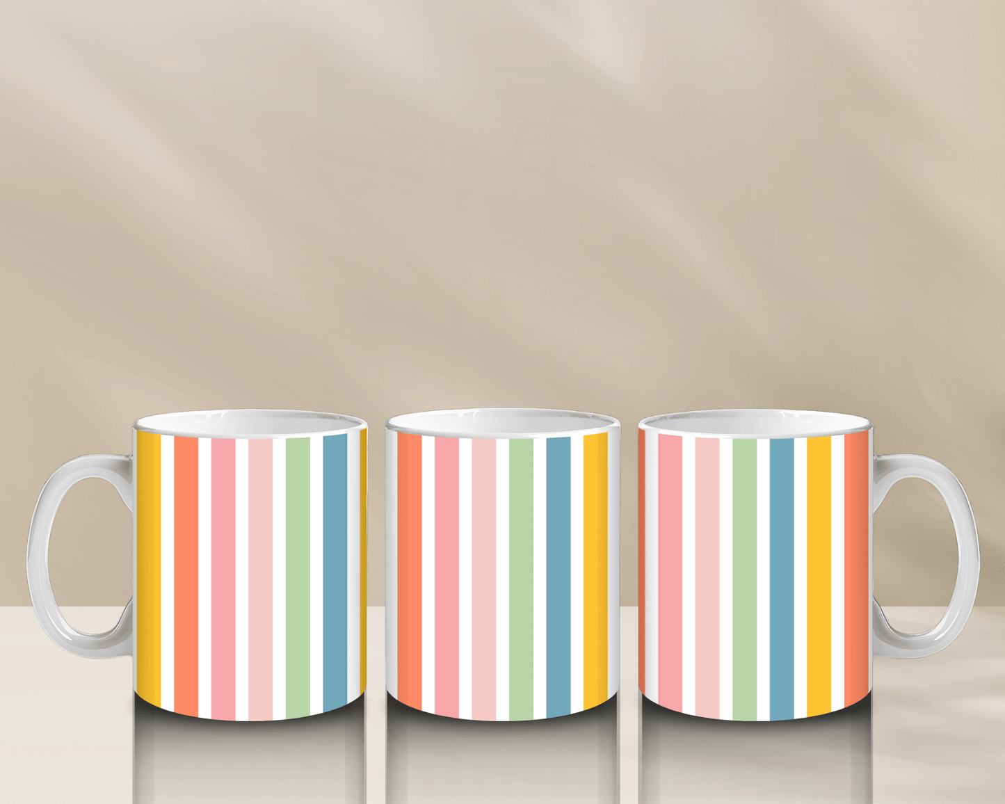 Colorful striped coffee mugs on a reflective surface.