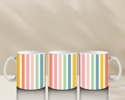 Colorful striped coffee mugs on a reflective surface.